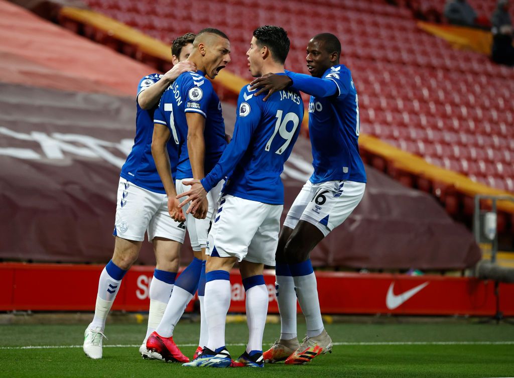LIVERPOOL, ENGLAND - FEBRUARY 20: Richarlison of Everton celebrates with teammates Seamus Coleman, James Rodriguez and Abdoulaye Doucoure after scoring his team's first goal during the Premier League match between Liverpool and Everton at Anfield on February 20, 2021 in Liverpool, England. Sporting stadiums around the UK remain under strict restrictions due to the Coronavirus Pandemic as Government social distancing laws prohibit fans inside venues resulting in games being played behind closed doors. (Photo by Phil Noble - Pool/Getty Images)