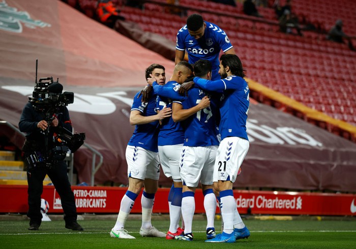 LIVERPOOL, ENGLAND - FEBRUARY 20: Richarlison of Everton celebrates with teammates Seamus Coleman, Mason Holgate, James Rodriguez and Andre Gomes  after scoring his teams first goal during the Premier League match between Liverpool and Everton at Anfield on February 20, 2021 in Liverpool, England. Sporting stadiums around the UK remain under strict restrictions due to the Coronavirus Pandemic as Government social distancing laws prohibit fans inside venues resulting in games being played behind closed doors. (Photo by Phil Noble - Pool/Getty Images)