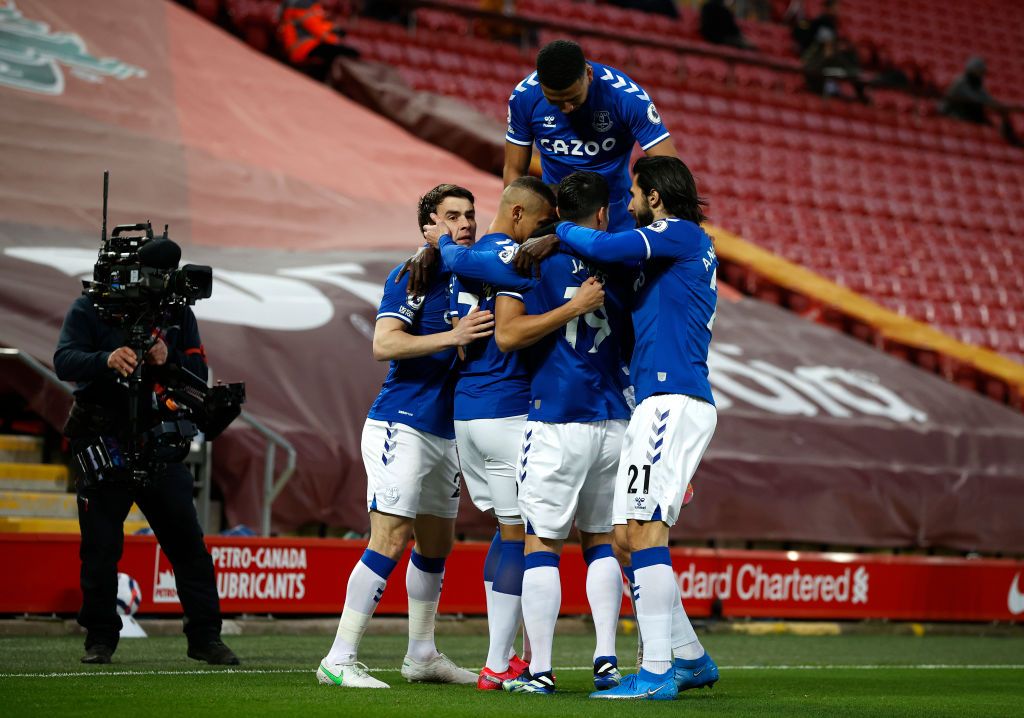 LIVERPOOL, ENGLAND - FEBRUARY 20: Richarlison of Everton celebrates with teammates Seamus Coleman, Mason Holgate, James Rodriguez and Andre Gomes  after scoring his team's first goal during the Premier League match between Liverpool and Everton at Anfield on February 20, 2021 in Liverpool, England. Sporting stadiums around the UK remain under strict restrictions due to the Coronavirus Pandemic as Government social distancing laws prohibit fans inside venues resulting in games being played behind closed doors. (Photo by Phil Noble - Pool/Getty Images)