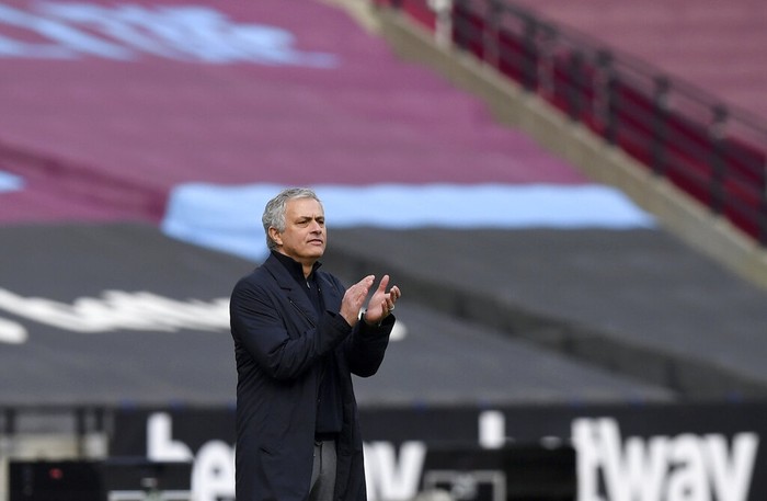 Tottenhams manager Jose Mourinho applauds during the English Premier League soccer match between West Ham United and Tottenham at the London Stadium in London, Saturday, Feb. 21, 2021. (Neil Hall/Pool via AP)