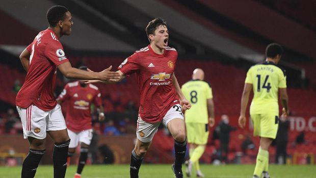 Manchester United's Daniel James, centre, celebrates after scoring his side's second goal during an English Premier League soccer match between Manchester United and Newcastle at the Old Trafford stadium in Manchester, England, Sunday Feb. 21, 2021. (Stu Forster/Pool via AP)