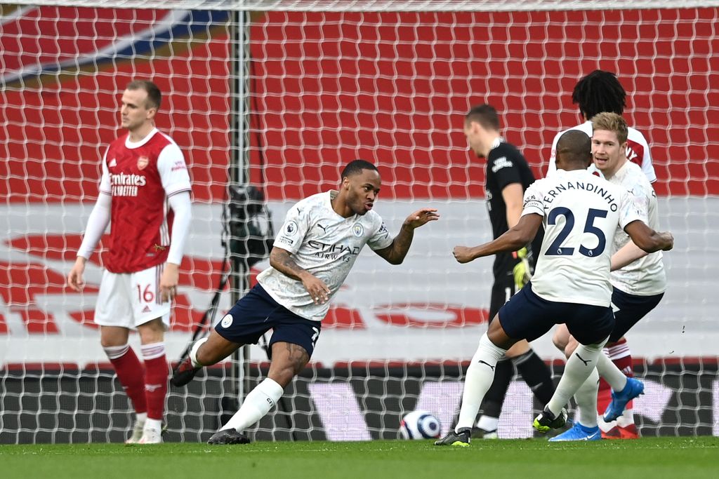 LONDON, ENGLAND - FEBRUARY 21: Raheem Sterling of Manchester City celebrates after scoring his team's first goal during the Premier League match between Arsenal and Manchester City at Emirates Stadium on February 21, 2021 in London, England. Sporting stadiums around the UK remain under strict restrictions due to the Coronavirus Pandemic as Government social distancing laws prohibit fans inside venues resulting in games being played behind closed doors. (Photo by Shaun Botterill/Getty Images)