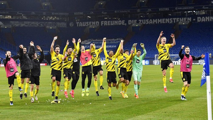 Dortmund players celebrate at the end of the German Bundesliga soccer match between FC Schalke 04 and Borussia Dortmund in Gelsenkirchen, Germany, Saturday, Feb. 20, 2021. Dortmund won 4-0. (AP Photo/Martin Meissner, Pool)