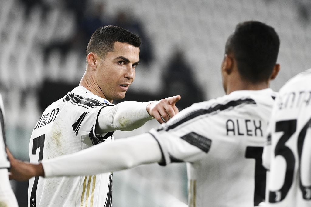 Juventus' Cristiano Ronaldo, left, celebrates after scoring during the Serie A soccer match between Juventus and Crotone, at the Allianz Stadium in Turin, Italy, Monday, Feb. 22, 2021. (Marco Alpozzi/LaPresse via AP)