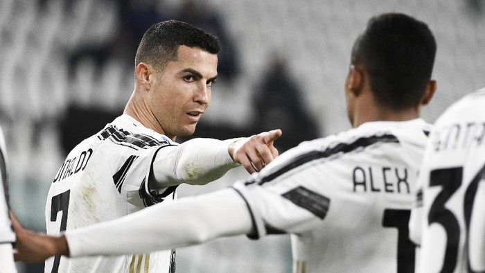 Juventus Cristiano Ronaldo, left, celebrates after scoring during the Serie A soccer match between Juventus and Crotone, at the Allianz Stadium in Turin, Italy, Monday, Feb. 22, 2021. (Marco Alpozzi/LaPresse via AP)