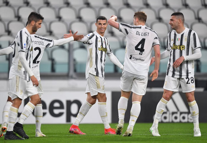 TURIN, ITALY - FEBRUARY 22: Cristiano Ronaldo of Juventus celebrates after scoring their teams first goal with Alex Sandro of Juventus during the Serie A match between Juventus  and FC Crotone at Allianz Stadium on February 22, 2021 in Turin, Italy. Sporting stadiums around Italy remain under strict restrictions due to the Coronavirus Pandemic as Government social distancing laws prohibit fans inside venues resulting in games being played behind closed doors. (Photo by Valerio Pennicino/Getty Images)