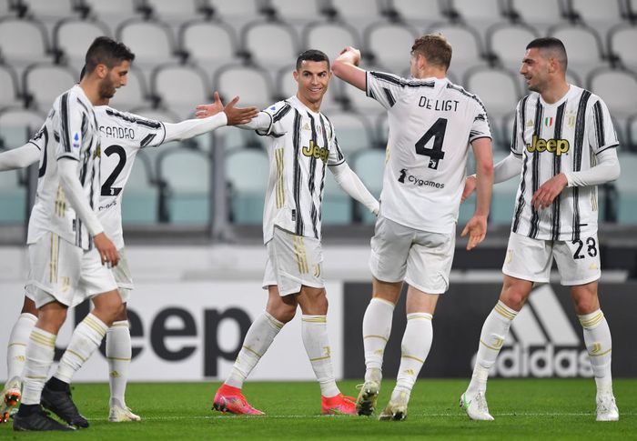 Juventus TURIN, ITALY - FEBRUARY 22: Cristiano Ronaldo of Juventus celebrates after scoring their teams first goal with Alex Sandro of Juventus during the Serie A match between Juventus and FC Crotone at Allianz Stadium on February 22, 2021 in Turin, Italy. Sporting stadiums around Italy remain under strict restrictions due to the Coronavirus Pandemic as Government social distancing laws prohibit fans inside venues resulting in games being played behind closed doors. (Photo by Valerio Pennicino/Getty Images)