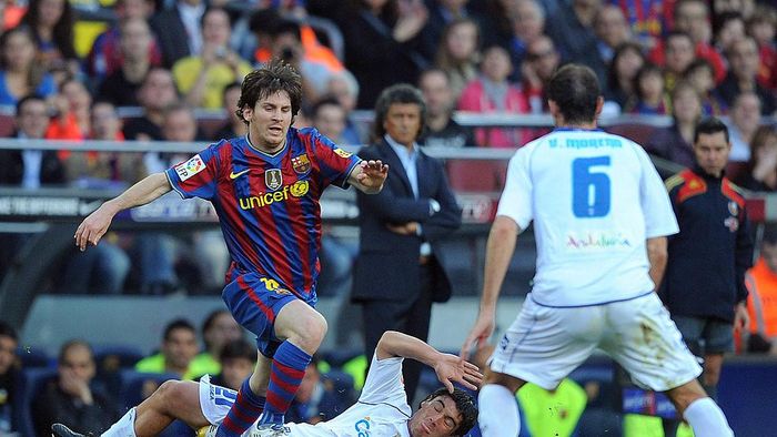 Lionel Messi BARCELONA, SPAIN - APRIL 24: Lionel Messi (L) of Barcelona beats Emilio Viqueira of Xerez CD during the La Liga match between Barcelona and Xerez CD at Camp Nou stadium on April 24, 2010 in Barcelona, Spain. (Photo by Denis Doyle/Getty Images)