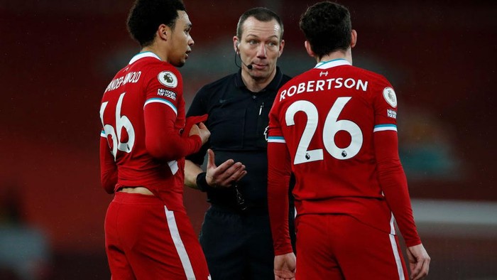 LIVERPOOL, ENGLAND - FEBRUARY 03: Trent Alexander-Arnold and Andy Robertson of Liverpool speak with Referee Kevin Friend during the Premier League match between Liverpool and Brighton & Hove Albion at Anfield on February 03, 2021 in Liverpool, England. Sporting stadiums around the UK remain under strict restrictions due to the Coronavirus Pandemic as Government social distancing laws prohibit fans inside venues resulting in games being played behind closed doors. (Photo by Phil Noble - Pool/Getty Images)