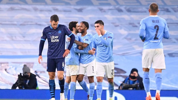 MANCHESTER, ENGLAND - DECEMBER 09: Raheem Sterling of Manchester City celebrates with teammates Bernando Silva and Ferran Torres after scoring their teams third goal during the UEFA Champions League Group C stage match between Manchester City and Olympique de Marseille at Etihad Stadium on December 09, 2020 in Manchester, England. The match will be played without fans, behind closed doors as a Covid-19 precaution. (Photo by Laurence Griffiths/Getty Images)