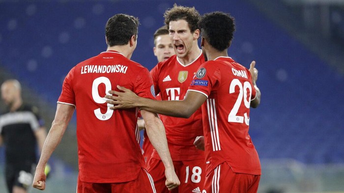 Bayerns Robert Lewandowski, left, celebrates with his teammates after scoring his sides opening goal during the Champions League round of 16 first leg soccer match between Lazio and Bayern Munich at the Olympic stadium in Rome, Tuesday, Feb. 23, 2021. (AP Photo/Gregorio Borgia)