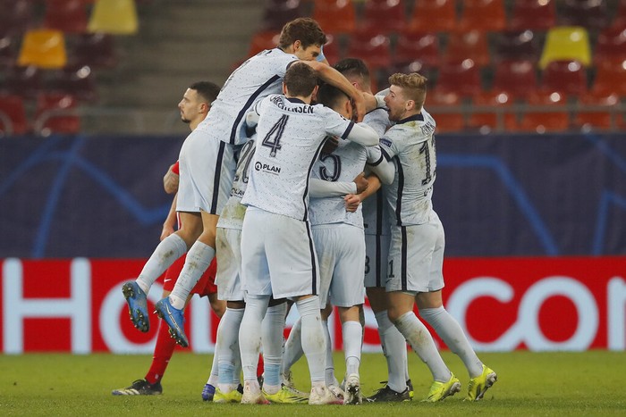 Chelseas Olivier Giroud celebrates with his teammates after scoring his sides first goal during the Champions League, round of 16, first leg soccer match between Atletico Madrid and Chelsea at the National Arena stadium in Bucharest, Romania, Tuesday, Feb. 23, 2021. (AP Photo/Vadim Ghirda)