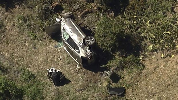 In this aerial image take from video provided by KABC-TV, a vehicle rest on its side after a rollover accident involving golfer Tiger Woods along a road in the Rancho Palos Verdes suburb of Los Angeles on Tuesday, Feb. 23, 2021. Woods had to be extricated from the vehicle with the 