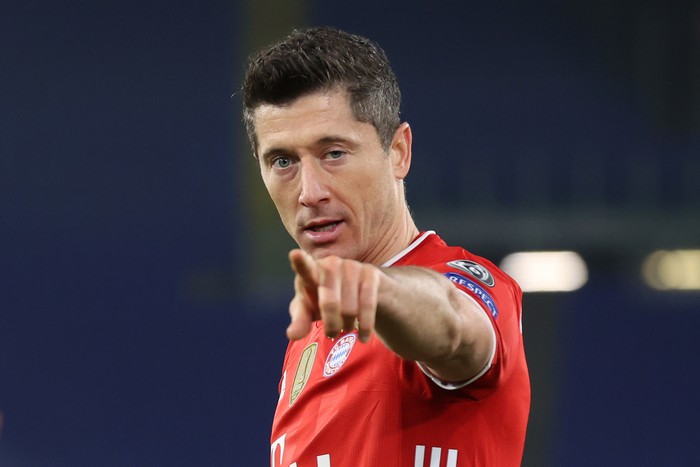 Robert Lewandowski ROME, ITALY - FEBRUARY 23: Robert Lewandowski of FC Bayern Muenchen celebrates after scoring their sides first goal during the UEFA Champions League Round of 16 match between Lazio Roma and Bayern MΓΌnchen at Olimpico Stadium on February 23, 2021 in Rome, Italy. Sporting stadiums around Italy remain under strict restrictions due to the Coronavirus Pandemic as Government social distancing laws prohibit fans inside venues resulting in games being played behind closed doors. (Photo by Alexander Hassenstein/Getty Images)