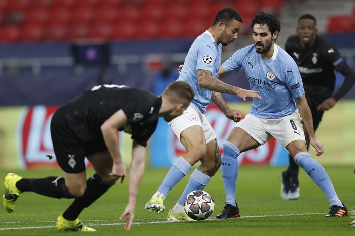Manchester Citys Gabriel Jesus, center, in action during the Champions League round of 16 first leg soccer match between Borussia Monchengladbach and Manchester City at the Puskas Arena stadium in Budapest, Hungary, Wednesday, Feb. 24, 2021. (AP Photo/Laszlo Balogh)