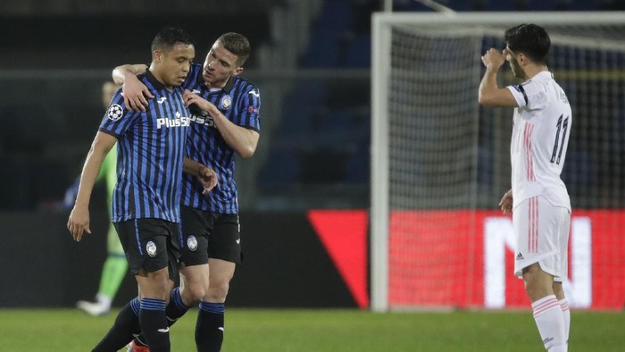 Atalantas Robin Gosens, center, comforts Atalantas Luis Muriel as he substituted during the Champions League, round of 16, first leg soccer match between Atlanta and Real Madrid, at the Gewiss Stadium in Bergamo, Wednesday, Feb. 24, 2021. (AP Photo/Luca Bruno)