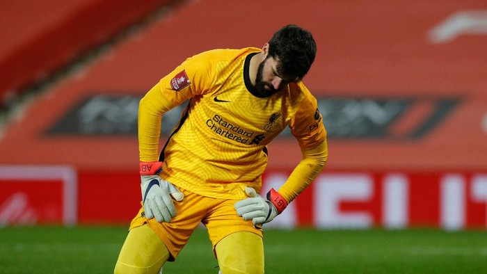 MANCHESTER, ENGLAND - JANUARY 24: Alisson Becker of Liverpool reacts as Marcus Rashford of Manchester United (not pictured) scores their sides second goal  during The Emirates FA Cup Fourth Round match between Manchester United and Liverpool at Old Trafford on January 24, 2021 in Manchester, England. Sporting stadiums around the UK remain under strict restrictions due to the Coronavirus Pandemic as Government social distancing laws prohibit fans inside venues resulting in games being played behind closed doors. (Photo by Phil Noble - Pool/Getty Images)
