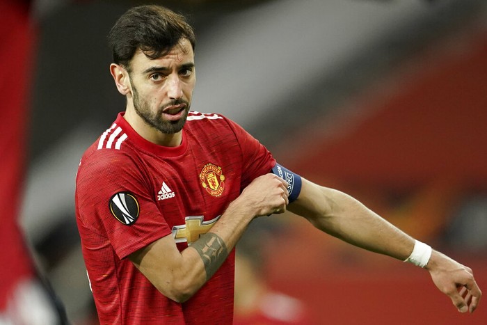 Manchester Uniteds Bruno Fernandes adjusts his captain armband during the Europa League round of 32, second leg, soccer match between Manchester United and Real Sociedad at Old Trafford in Manchester, England, Thursday, Feb. 25, 2021. (AP Photo/Dave Thompson)
