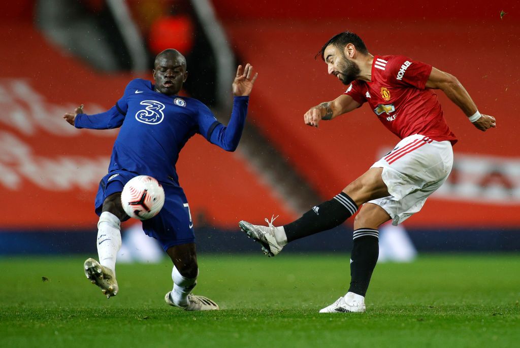 MANCHESTER, ENGLAND - OCTOBER 24: Bruno Fernandes of Manchester United shoots past Ngolo Kante of Chelsea  during the Premier League match between Manchester United and Chelsea at Old Trafford on October 24, 2020 in Manchester, England. Sporting stadiums around the UK remain under strict restrictions due to the Coronavirus Pandemic as Government social distancing laws prohibit fans inside venues resulting in games being played behind closed doors. (Photo by Phil Noble - Pool/Getty Images)