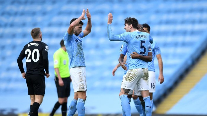 MANCHESTER, ENGLAND - FEBRUARY 27: Ruben Dias and John Stones of Manchester City celebrate following their teams victory in the Premier League match between Manchester City and West Ham United at Etihad Stadium on February 27, 2021 in Manchester, England. Sporting stadiums around the UK remain under strict restrictions due to the Coronavirus Pandemic as Government social distancing laws prohibit fans inside venues resulting in games being played behind closed doors. (Photo by Gareth Copley/Getty Images)
