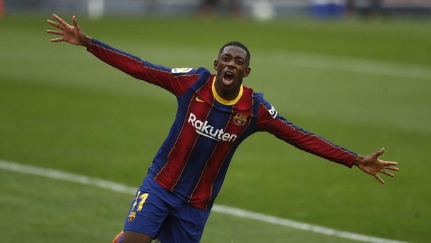 Barcelona's Ousmane Dembele celebrates after scoring during a Spanish La Liga soccer match between Sevilla and Barcelona at the Ramon Sanchez-Pizjuan stadium in Seville, Spain, Saturday Feb. 27, 2021. (AP Photo/Angel Fernandez)