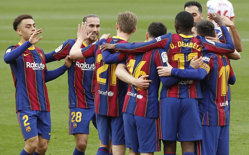 Barcelona's Ousmane Dembele, third right, celebrates with teammates after scoring during a Spanish La Liga soccer match between Sevilla and Barcelona at the Ramon Sanchez-Pizjuan stadium in Seville, Spain, Saturday Feb. 27, 2021. (AP Photo/Angel Fernandez)