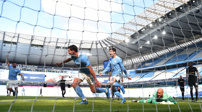 MANCHESTER, ENGLAND - FEBRUARY 27: Ruben Dias of Manchester City celebrates after scoring his teams first goal alongside John Stones during the Premier League match between Manchester City and West Ham United at Etihad Stadium on February 27, 2021 in Manchester, England. Sporting stadiums around the UK remain under strict restrictions due to the Coronavirus Pandemic as Government social distancing laws prohibit fans inside venues resulting in games being played behind closed doors. (Photo by Gareth Copley/Getty Images)