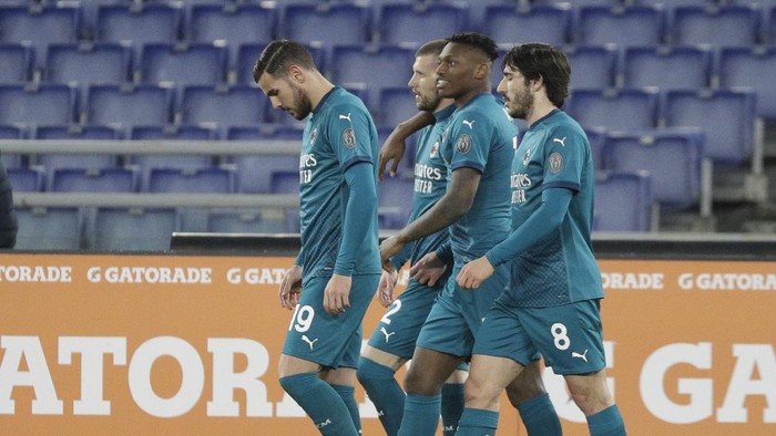 AC Milans Ante Rebic, second left celebrates with teammates after scoring his sides 2nd goal during the Serie A soccer match between AS Roma and AC Milan at the Olympic stadium, in Rome, Italy, Sunday, Feb. 28, 2021.(AP Photo/Gregorio Borgia)