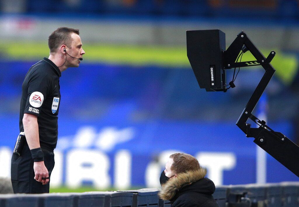 Referee Stuart Attwell watching the VAR monitor during the English Premier League soccer match between Chelsea and Manchester United at Stamford Bridge Stadium in London, England, Sunday, Feb. 28, 2021. (AP Photo/Ian Walton, Pool)