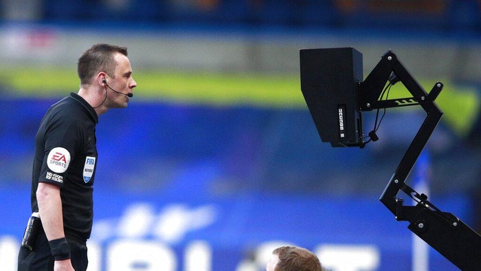 Referee Stuart Attwell watching the VAR monitor during the English Premier League soccer match between Chelsea and Manchester United at Stamford Bridge Stadium in London, England, Sunday, Feb. 28, 2021. (AP Photo/Ian Walton, Pool)