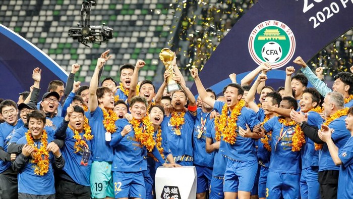 (FILES) This file photo taken on November 12, 2020 shows Jiangsu Suning players and staff members celebrating after their team defeated Guangzhou Evergrande to win the Chinese Super League (CSL) football championship in Suzhou, in Chinas eastern Jiangsu province. - The 