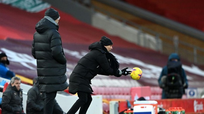 LIVERPOOL, ENGLAND - FEBRUARY 07: Pep Guardiola, Manager of Manchester City throws the ball during the Premier League match between Liverpool and Manchester City at Anfield on February 07, 2021 in Liverpool, England. Sporting stadiums around the UK remain under strict restrictions due to the Coronavirus Pandemic as Government social distancing laws prohibit fans inside venues resulting in games being played behind closed doors. (Photo by Laurence Griffiths/Getty Images)