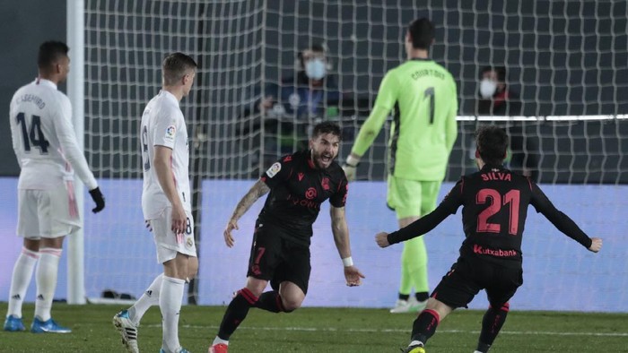 Real Sociedads Portu, center, celebrates with teammate Real Sociedads David Silva after scoring during the Spanish La Liga soccer match between Real Madrid and Real Sociedad at Alfredo di Stefano stadium in Madrid, Spain, Monday, March 1, 2021. (AP Photo/Bernat Armangue)