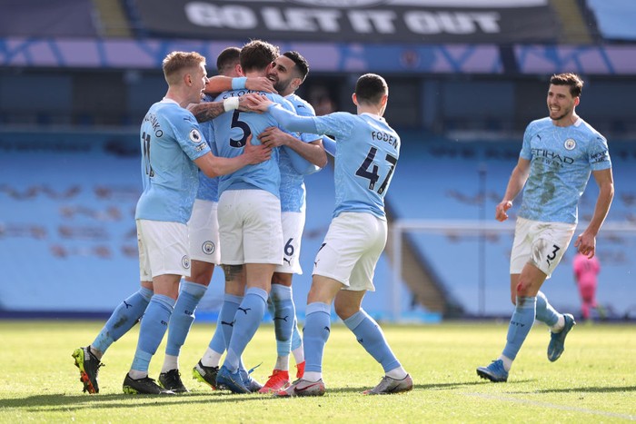 Manchester City MANCHESTER, ENGLAND - FEBRUARY 27: John Stones of Manchester City celebrates with teammates Oleksandr Zinchenko, Riyad Mahrez, Phil Foden and Ruben Dias after scoring his team's second goal during the Premier League match between Manchester City and West Ham United at Etihad Stadium on February 27, 2021 in Manchester, England. Sporting stadiums around the UK remain under strict restrictions due to the Coronavirus Pandemic as Government social distancing laws prohibit fans inside venues resulting in games being played behind closed doors. (Photo by Clive Brunskill/Getty Images)