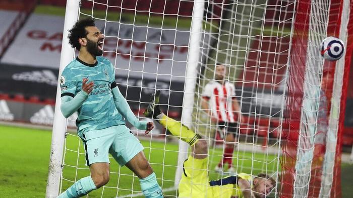 Liverpools Mohamed Salah screams after missing a chance to pass Sheffield Uniteds goalkeeper Aaron Ramsdale, right, and score during the English Premier League soccer match between Sheffield United and Liverpool at Bramall Lane stadium in Sheffield, England, Sunday, Feb. 28, 2021. (Lee Smith, Pool via AP)