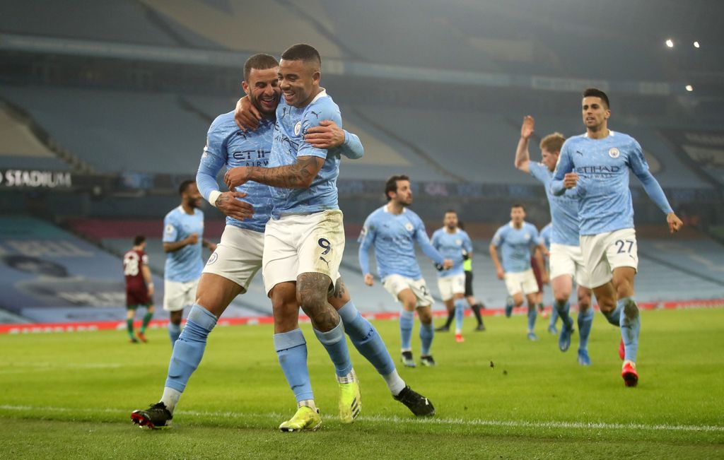 MANCHESTER, ENGLAND - MARCH 02: Gabriel Jesus of Manchester City celebrates with team mate Kyle Walker after scoring their side's second goal during the Premier League match between Manchester City and Wolverhampton Wanderers at Etihad Stadium on March 02, 2021 in Manchester, England. Sporting stadiums around the UK remain under strict restrictions due to the Coronavirus Pandemic as Government social distancing laws prohibit fans inside venues resulting in games being played behind closed doors. (Photo by Carl Recine - Pool/Getty Images)