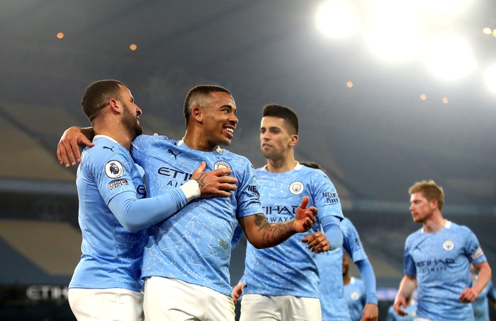 MANCHESTER, ENGLAND - MARCH 02: Gabriel Jesus of Manchester City celebrates with team mate Kyle Walker after scoring their sides second goal during the Premier League match between Manchester City and Wolverhampton Wanderers at Etihad Stadium on March 02, 2021 in Manchester, England. Sporting stadiums around the UK remain under strict restrictions due to the Coronavirus Pandemic as Government social distancing laws prohibit fans inside venues resulting in games being played behind closed doors. (Photo by Carl Recine - Pool/Getty Images)