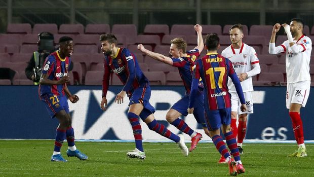 Barcelona's Gerard Pique, 2nd left, celebrates after scoring his side's second goal during the the Copa del Rey semifinal, second leg, soccer match between FC Barcelona and Sevilla FC at the Camp Nou stadium in Barcelona, Spain, Wednesday March 3, 2021. (AP Photo/Joan Monfort)