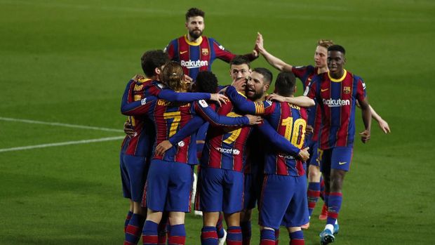 Barcelona players celebrate after scoring their third goal during the the Copa del Rey semifinal, second leg, soccer match between FC Barcelona and Sevilla FC at the Camp Nou stadium in Barcelona, Spain, Wednesday March 3, 2021. (AP Photo/Joan Monfort)