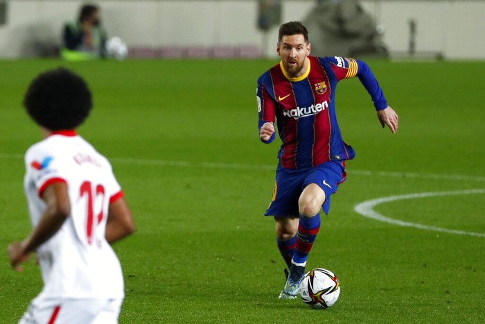 Barcelonas Lionel Messi runs with the ball during the the Copa del Rey semifinal, second leg, soccer match between FC Barcelona and Sevilla FC at the Camp Nou stadium in Barcelona, Spain, Wednesday March 3, 2021. (AP Photo/Joan Monfort)