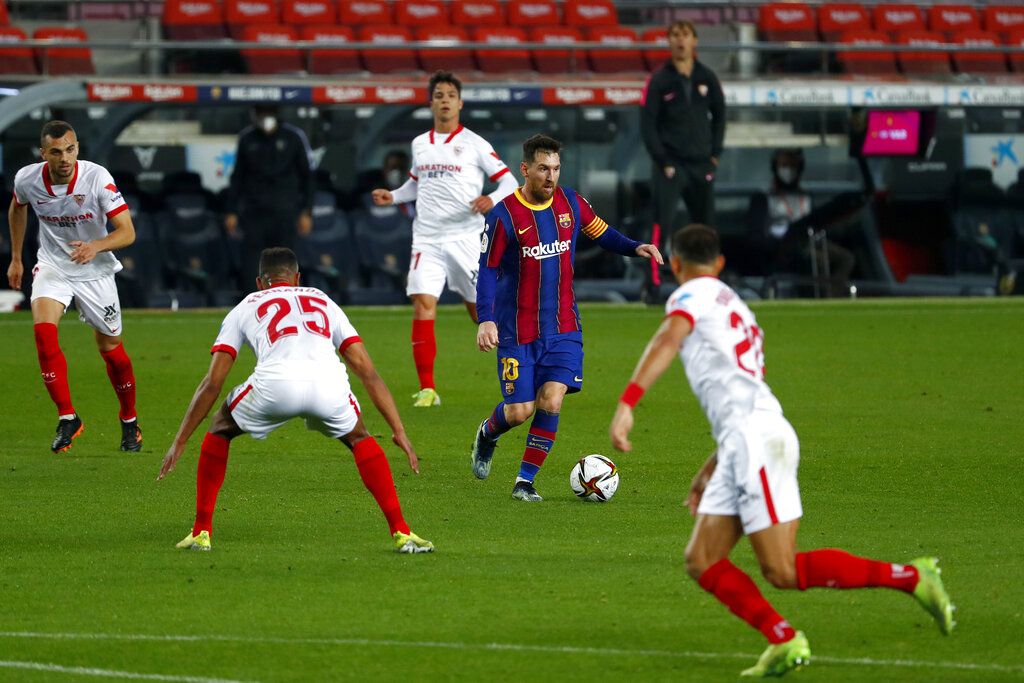 Barcelona's Lionel Messi runs with the ball during the the Copa del Rey semifinal, second leg, soccer match between FC Barcelona and Sevilla FC at the Camp Nou stadium in Barcelona, Spain, Wednesday March 3, 2021. (AP Photo/Joan Monfort)