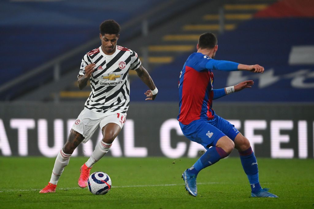 LONDON, ENGLAND - MARCH 03: Manchester United's Marcus Rashford shoots under pressure from Crystal Palace's Gary Cahill during the Premier League match between Crystal Palace and Manchester United at Selhurst Park on March 03, 2021 in London, England.  Sports stadiums across the UK remain under strict restrictions due to the coronavirus pandemic, as government social distancing laws prohibit fans within venues, causing games to be played behind closed doors.  (Photo by Mike Hewitt / Getty Images)