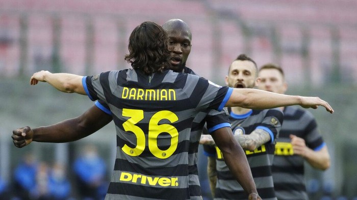 Inter Milans Matteo Darmian, left, celebrates with his teammate Inter Milans Romelu Lukaku after scoring his sides second goal during a Serie A soccer match between Inter Milan and Genoa at the San Siro stadium in Milan, Italy, Sunday, Feb. 28, 2021. (AP Photo/Luca Bruno)