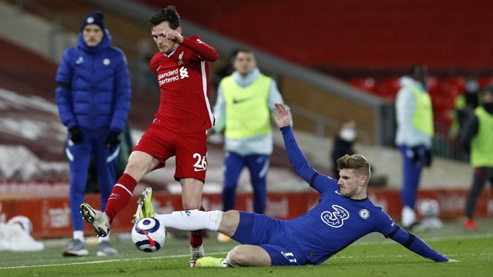 LIVERPOOL, ENGLAND - MARCH 04: Andy Robertson of Liverpool is challenged by Timo Werner of Chelsea during the Premier League match between Liverpool and Chelsea at Anfield on March 04, 2021 in Liverpool, England. Sporting stadiums around the UK remain under strict restrictions due to the Coronavirus Pandemic as Government social distancing laws prohibit fans inside venues resulting in games being played behind closed doors. (Photo by Phil Noble - Pool/Getty Images)