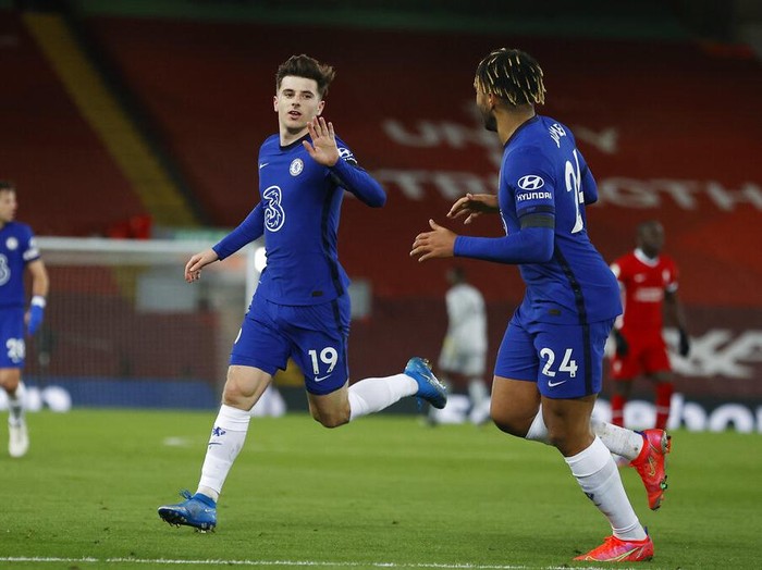 Chelsea's Mason Mount, left, celebrates with his teammate Reece James after scoring his side's opening goal during the English Premier League soccer match between Liverpool and Chelsea at Anfield stadium in Liverpool, England, Thursday, March 4, 2021. (Phil Noble, Pool via AP)