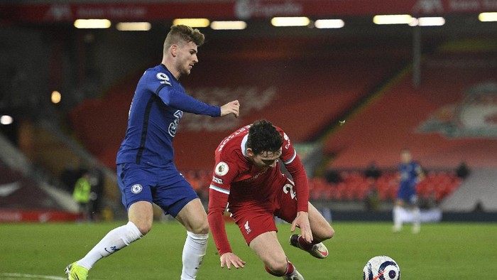 Chelseas Timo Werner, left, challenges for the ball with Liverpools Andrew Robertson during the English Premier League soccer match between Liverpool and Chelsea at Anfield stadium in Liverpool, England, Thursday, March 4, 2021. (Oli Scarff, Pool via AP)