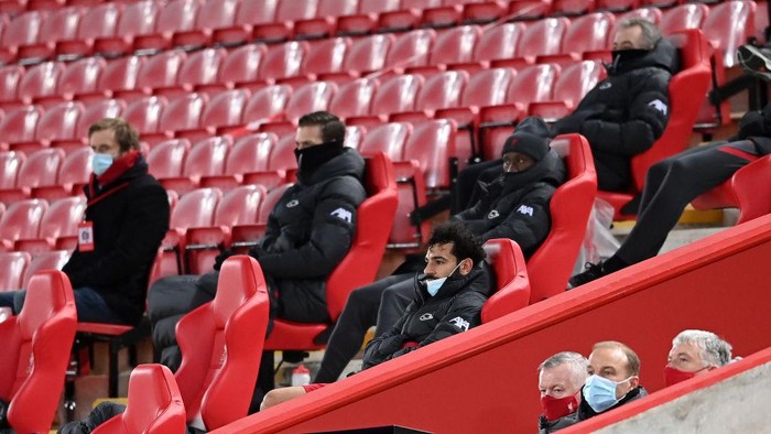 LIVERPOOL, ENGLAND - MARCH 04: Mohamed Salah of Liverpool looks on from the bench after being substituted off during the Premier League match between Liverpool and Chelsea at Anfield on March 04, 2021 in Liverpool, England. Sporting stadiums around the UK remain under strict restrictions due to the Coronavirus Pandemic as Government social distancing laws prohibit fans inside venues resulting in games being played behind closed doors. (Photo by Laurence Griffiths/Getty Images)