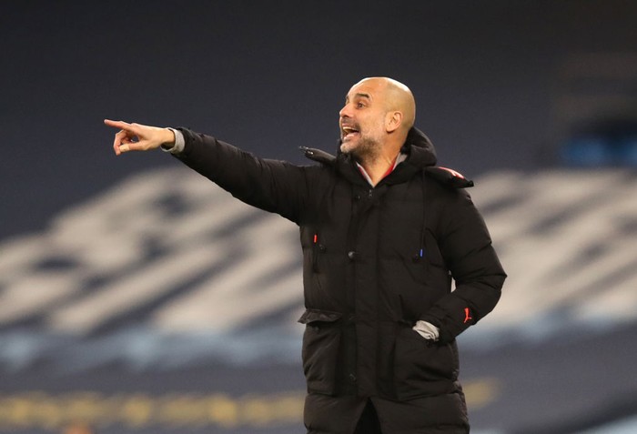 MANCHESTER, ENGLAND - JANUARY 17: Pep Guardiola, Manager of Manchester City gives their team instructions during the Premier League match between Manchester City and Crystal Palace at Etihad Stadium on January 17, 2021 in Manchester, England. Sporting stadiums around England remain under strict restrictions due to the Coronavirus Pandemic as Government social distancing laws prohibit fans inside venues resulting in games being played behind closed doors. (Photo by Clive Brunskill/Getty Images)