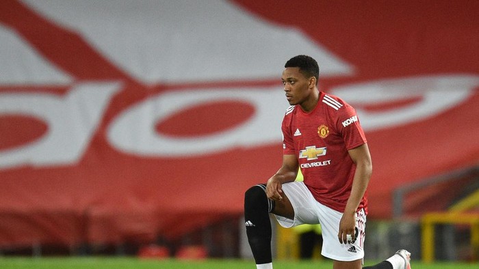 MANCHESTER, ENGLAND - FEBRUARY 21: Anthony Martial of Manchester United takes a knee in support of the Black Lives Matter movement prior to the Premier League match between Manchester United and Newcastle United at Old Trafford on February 21, 2021 in Manchester, England. Sporting stadiums around the UK remain under strict restrictions due to the Coronavirus Pandemic as Government social distancing laws prohibit fans inside venues resulting in games being played behind closed doors. (Photo by Oli Scarff - Pool/Getty Images)