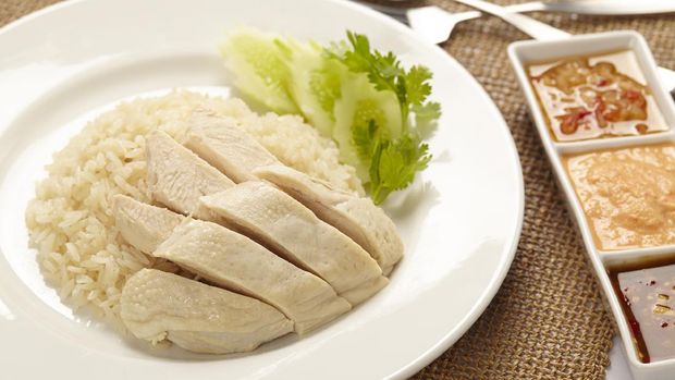 Hainanese Chicken rice with sauce in a plate on white background